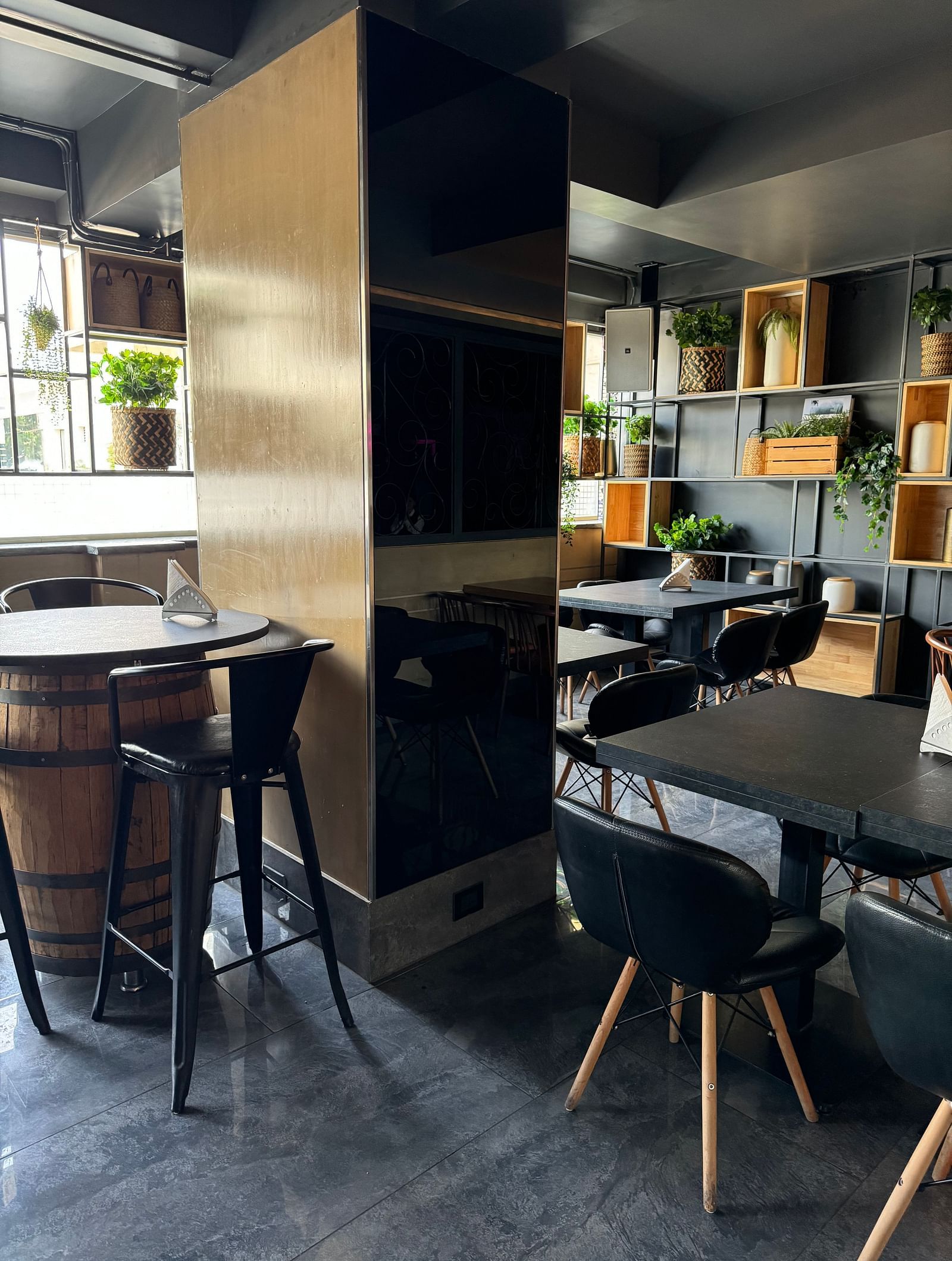 A modern dining area with dark furniture and subtle lighting at Cenneys Gateway.