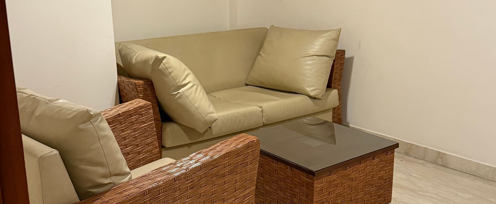 A spacious room with cushioned sofas and a table | Cenneys Gateway