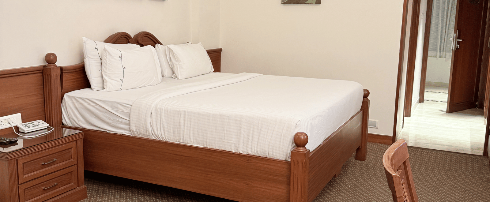 A side view of a large bed with photo frames above the headboard | Cenneys Gateway