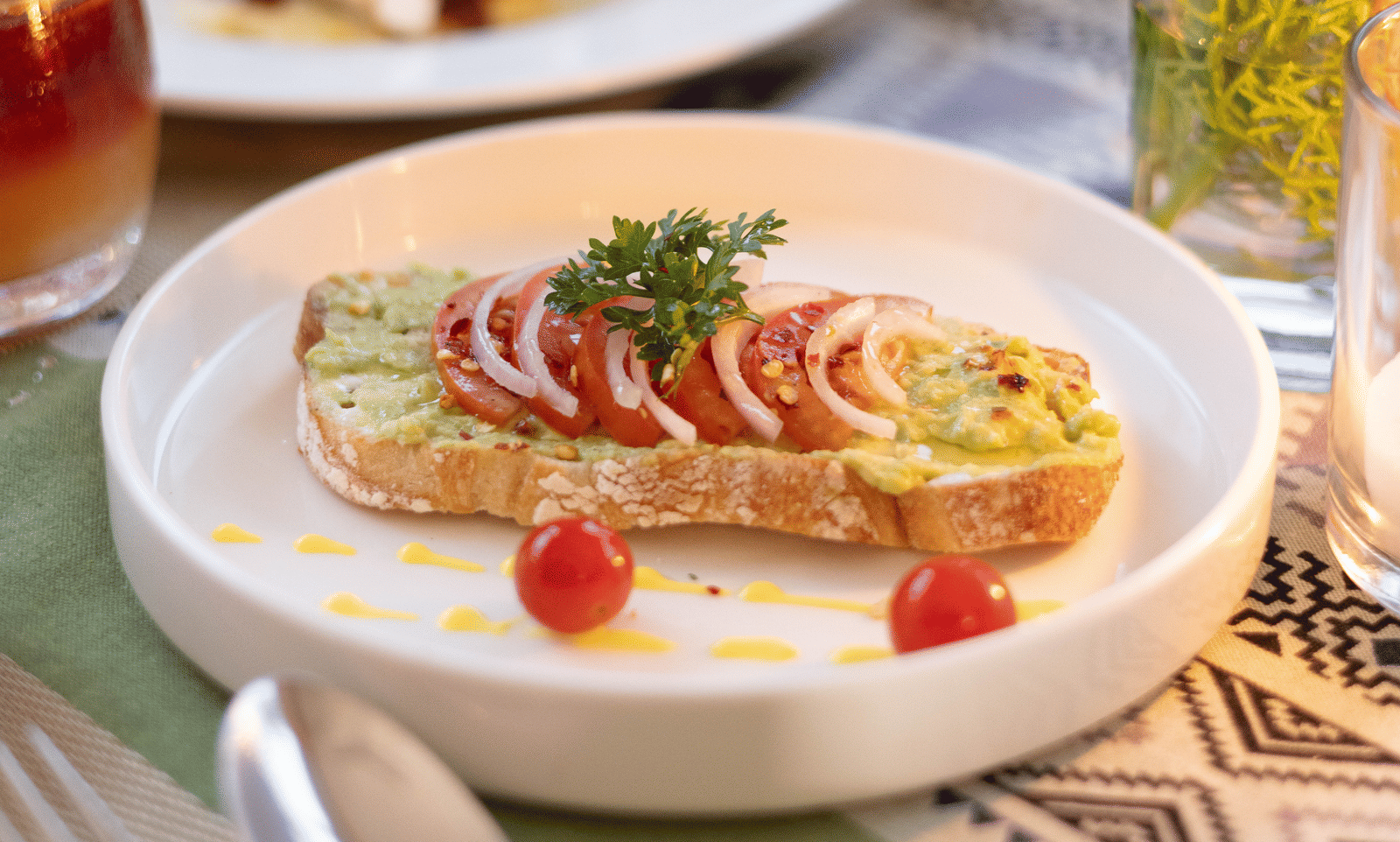 A close-up shot of an appetiser or dessert, featuring fruit and a creamy topping, on a white plate - Megha Resort & Villas, Dehradun
