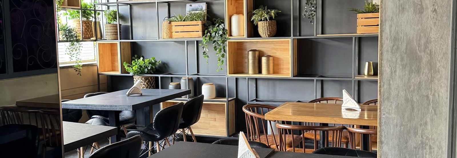 A dining area with a table and chairs, and decorative shelving at Cenneys Gateway.