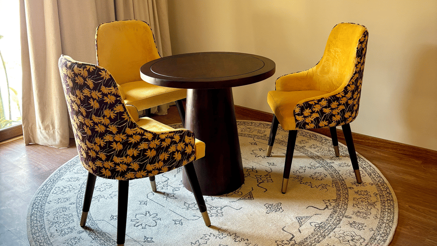 Dining area at the Vana Suite featuring three chairs and a centre table at Surpura Bagh.