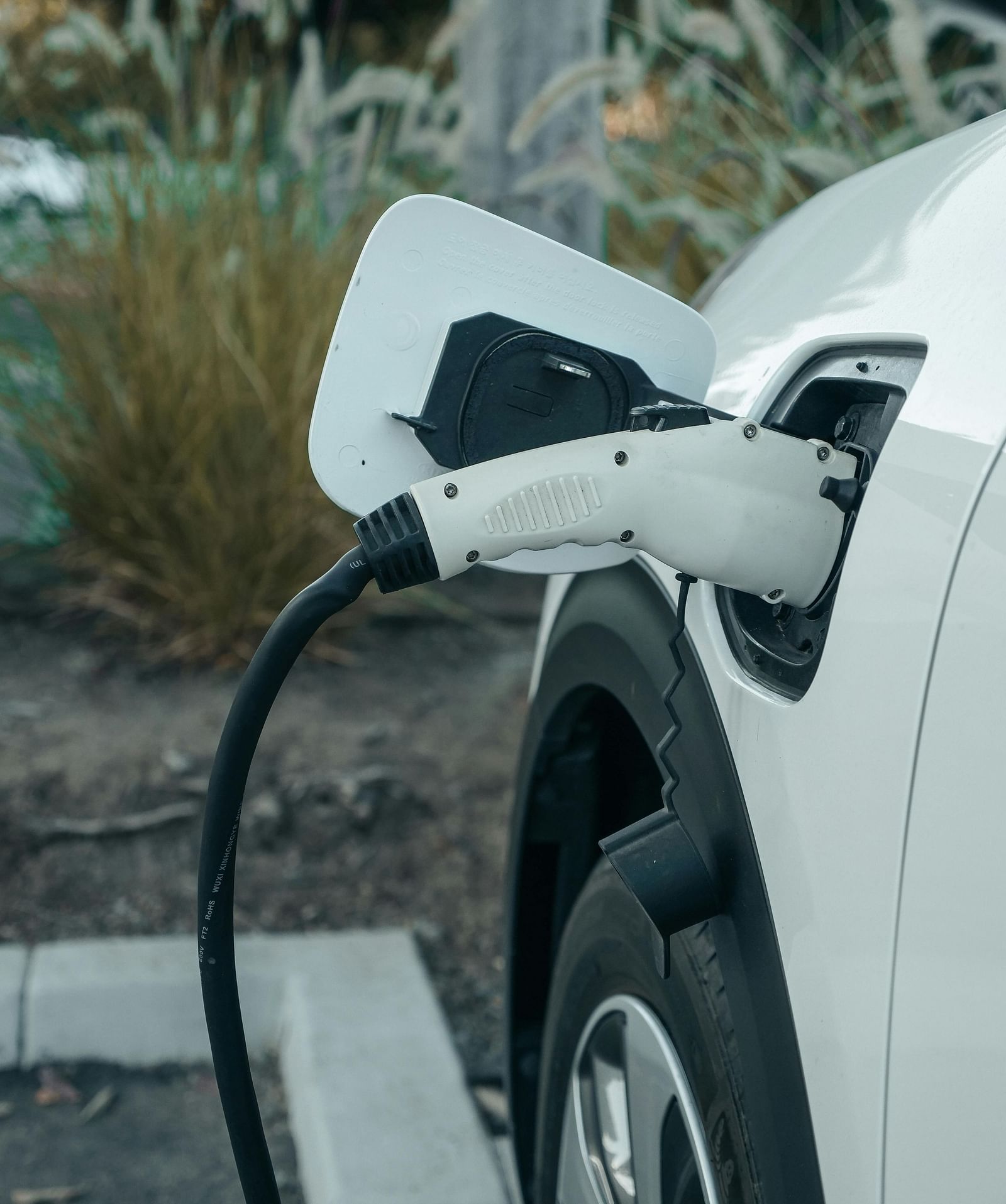 A car connected to an EV charger.