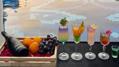 A luxurious poolside setup with colourful cocktails and fresh fruits - Kaldan Samudra Palace