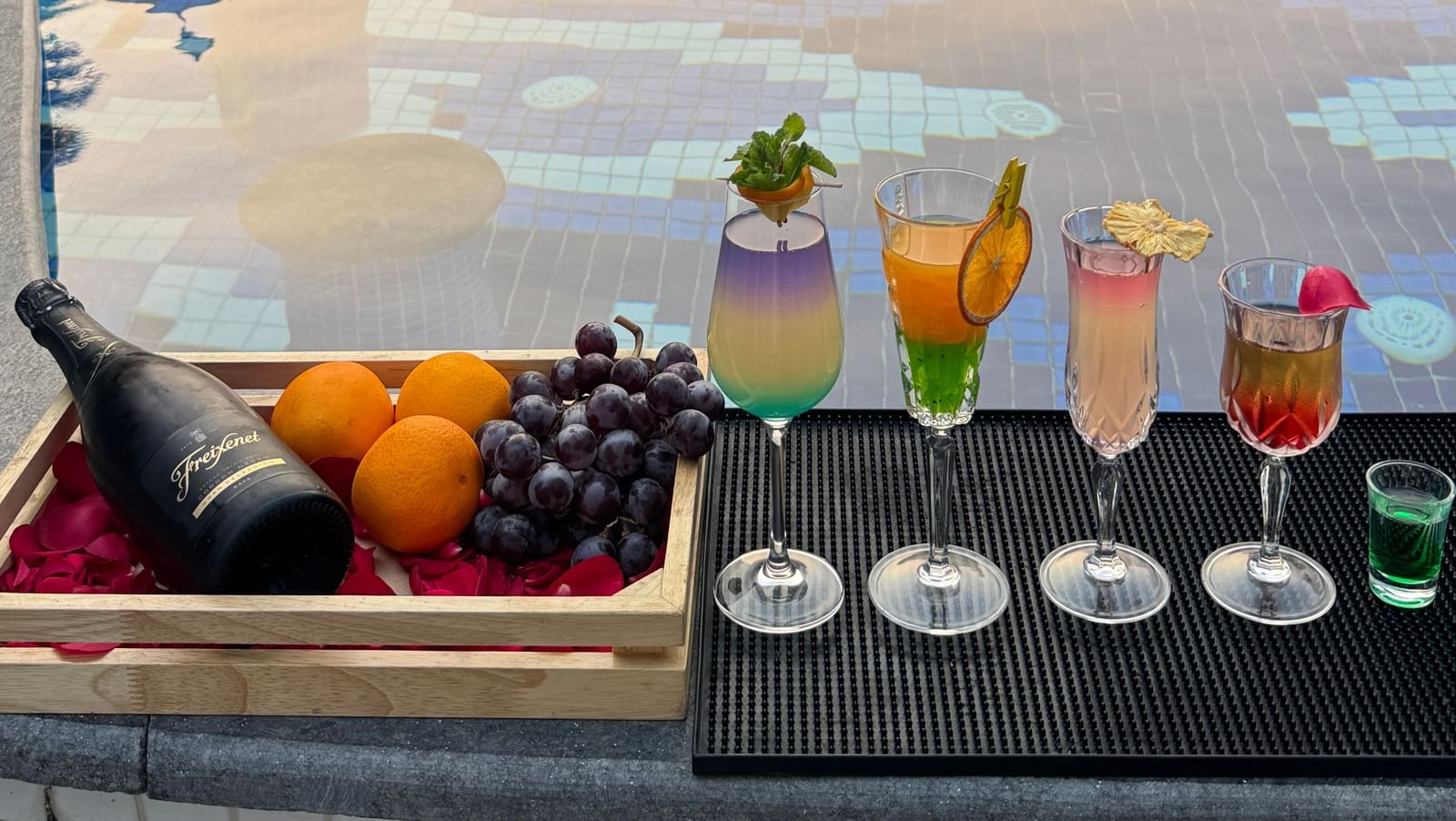 A luxurious poolside setup with colourful cocktails and fresh fruits - Kaldan Samudra Palace