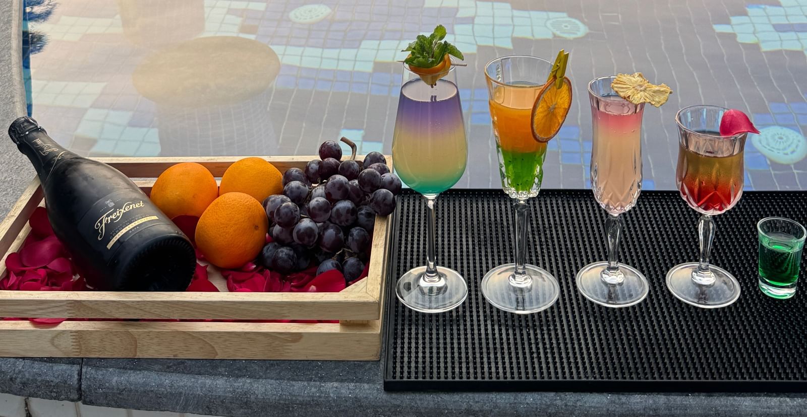 A luxurious poolside setup with colourful cocktails and fresh fruits - Kaldan Samudra Palace