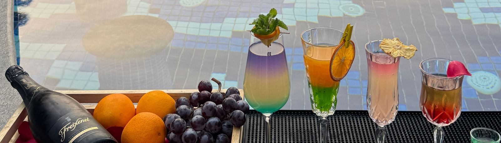 A luxurious poolside setup with colourful cocktails and fresh fruits - Kaldan Samudra Palace