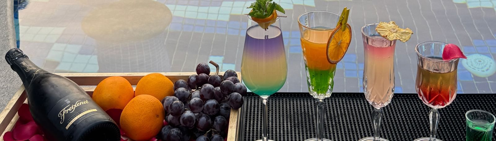 A luxurious poolside setup with colourful cocktails and fresh fruits - Kaldan Samudra Palace
