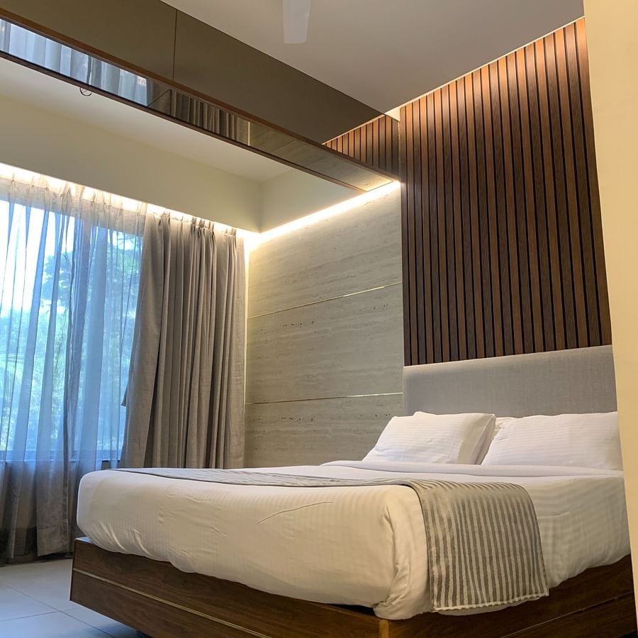 view of a king size bed at Stable facing room in Lonavala - Zara's Resort