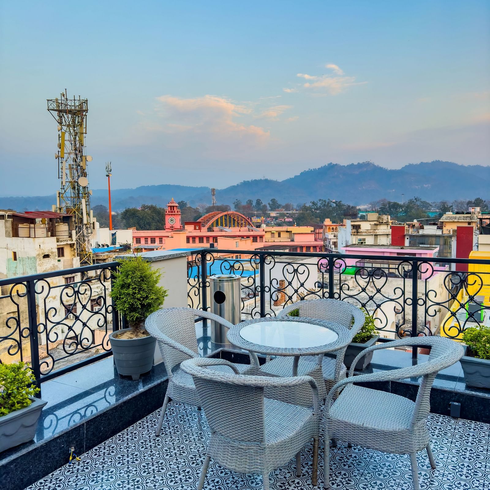 Another angle of serene views of Haridwar seen from the roof top restaurant with a round table in fore front - Wonder hills