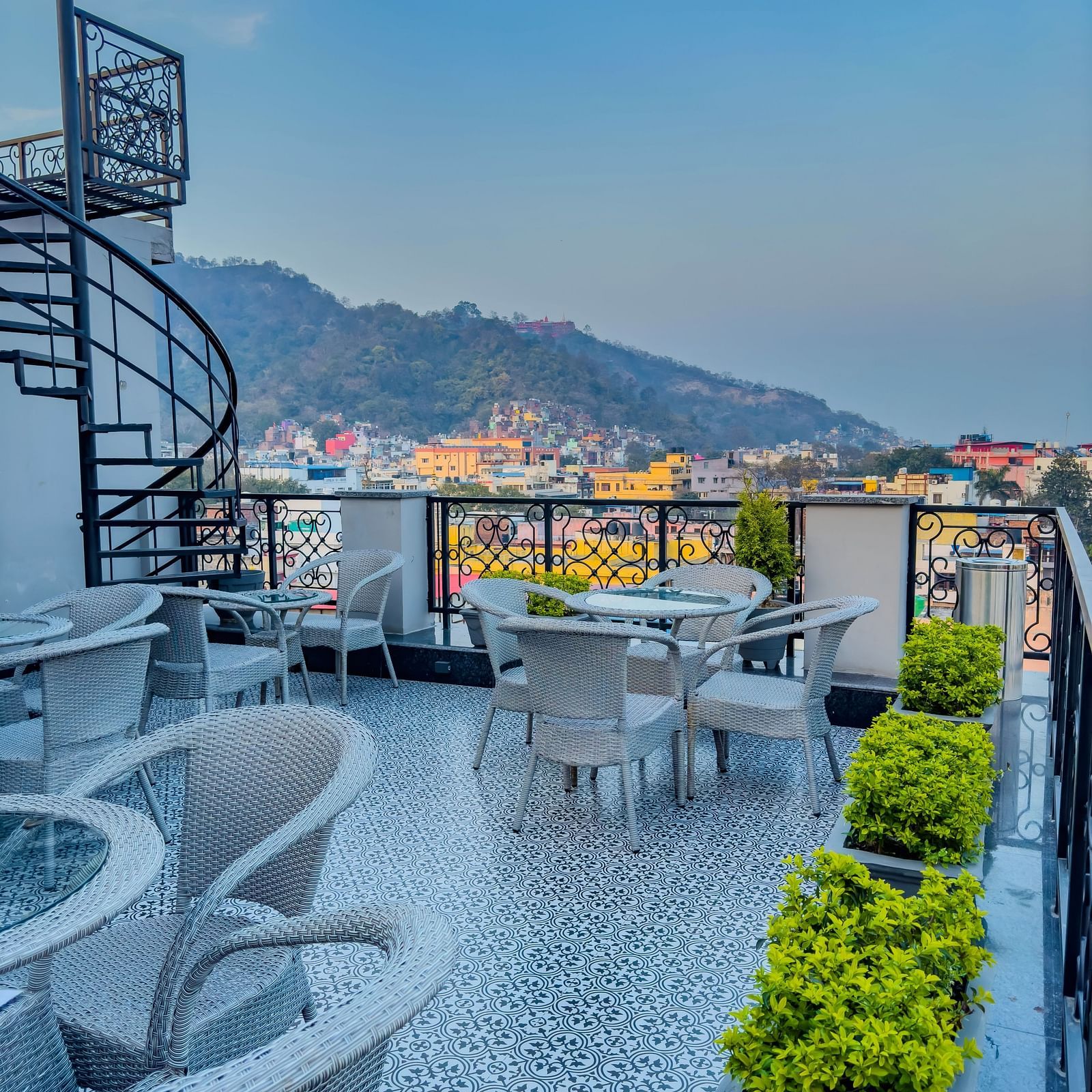 A view of a roof top restaurant which has a serene view of the mountains - Wonder Hills