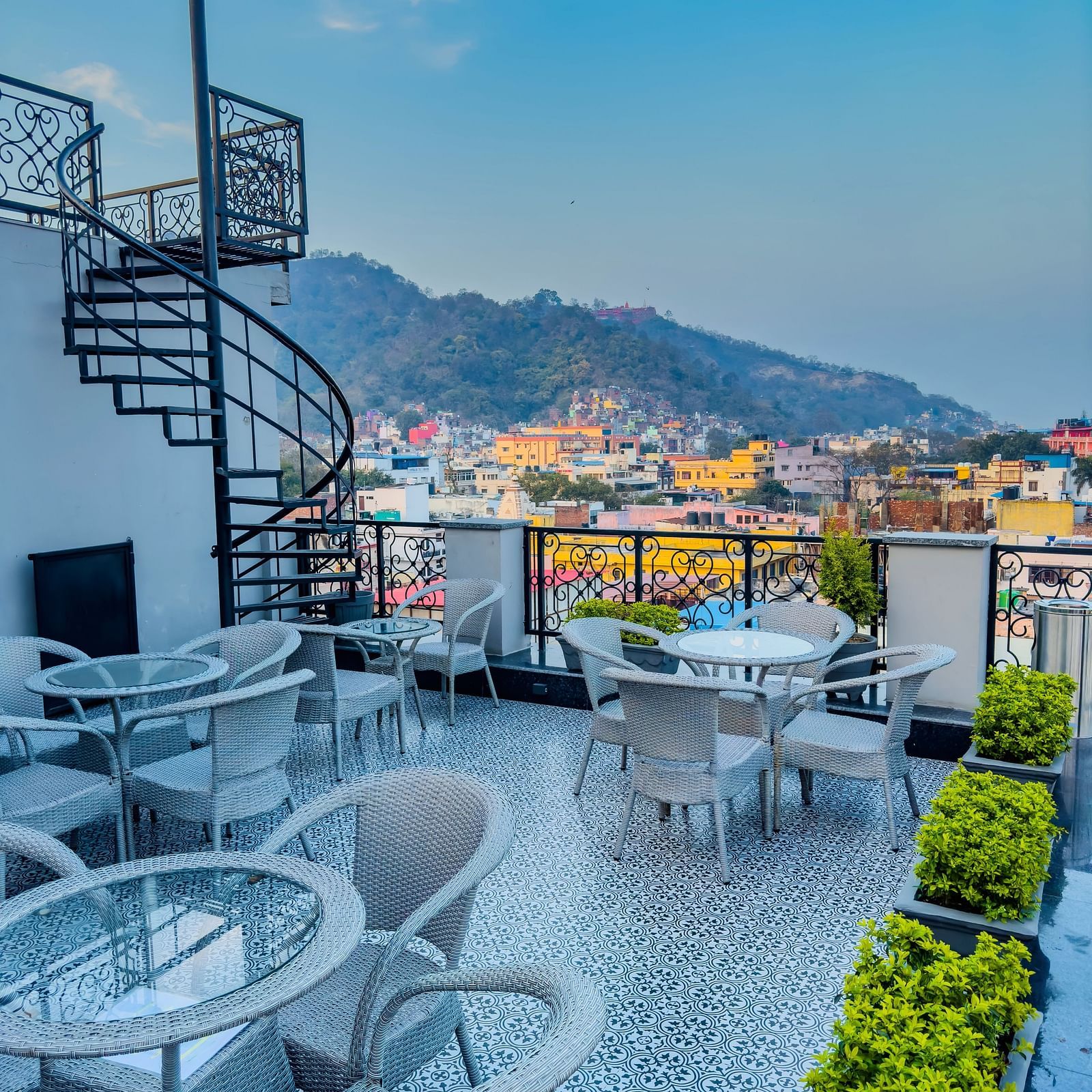 A roof top restaurant with a scenic view of the hill in the background - Wonder Hills