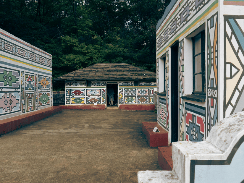 A traditional building at a tribal museum with geometric patterns and steps leading to the entrance.