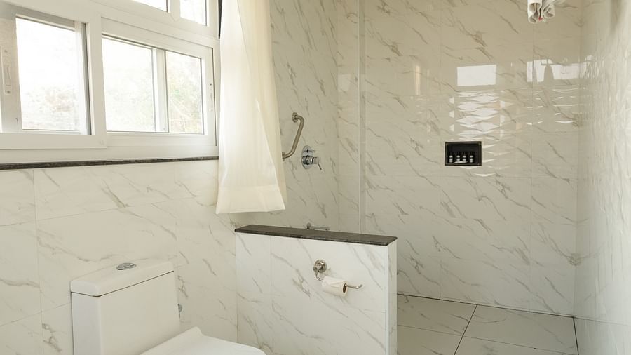 A clean and modern bathroom with a shower, sink, and toilet - MGM Whispering Wind's Resorts