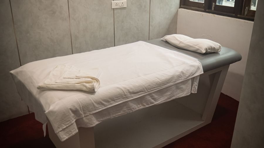 Cozy single spa bed at Mansha Regency, Port Blair, in a serene, softly lit treatment room.