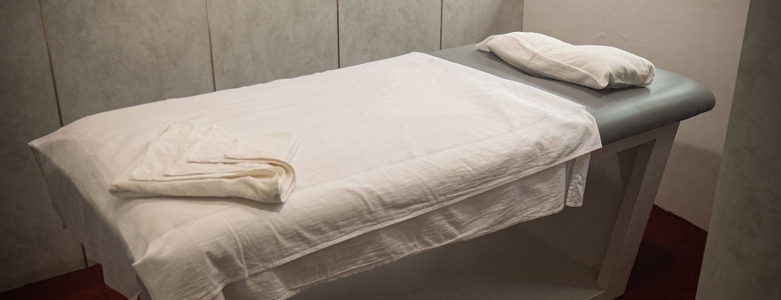 Cozy single spa bed at Mansha Regency, Port Blair, in a serene, softly lit treatment room.