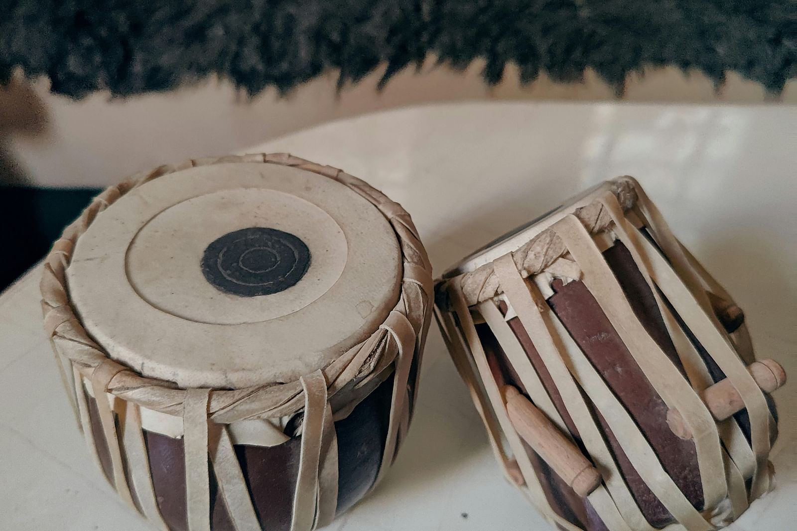 a close up image of a pair of tabla kept on a white surface