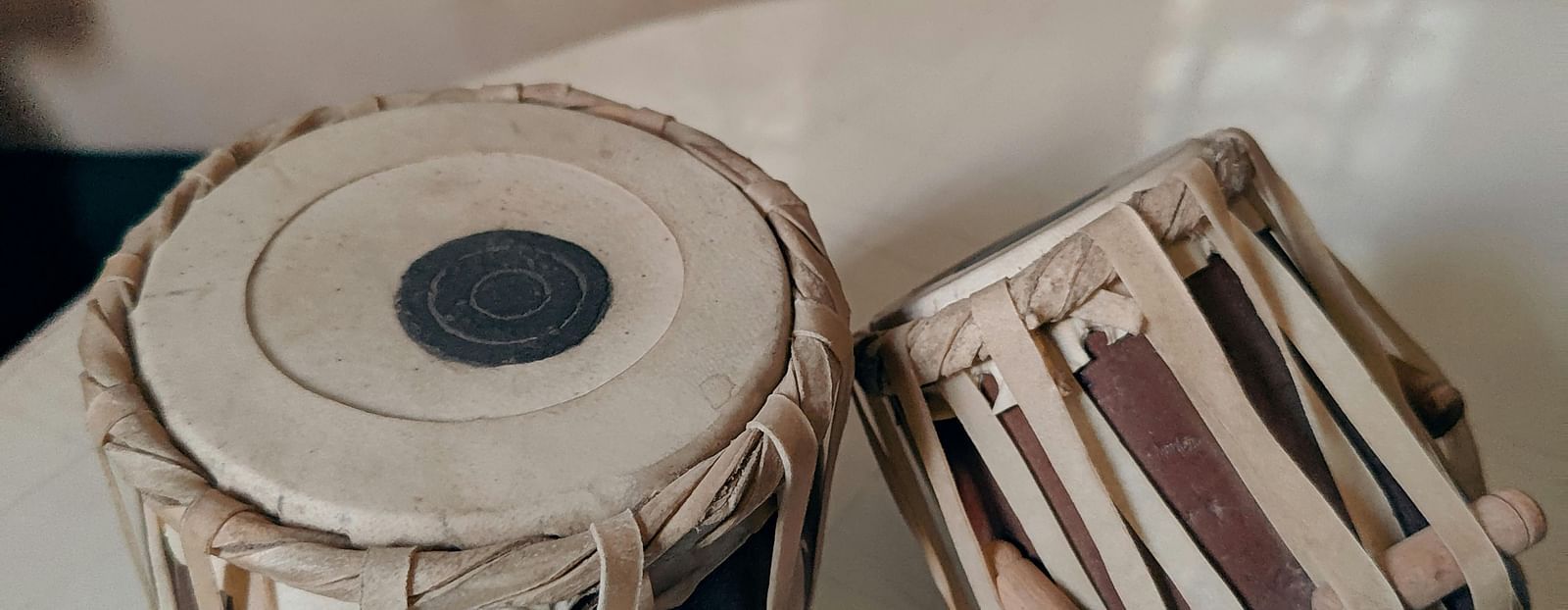 a close up image of a pair of tabla kept on a white surface
