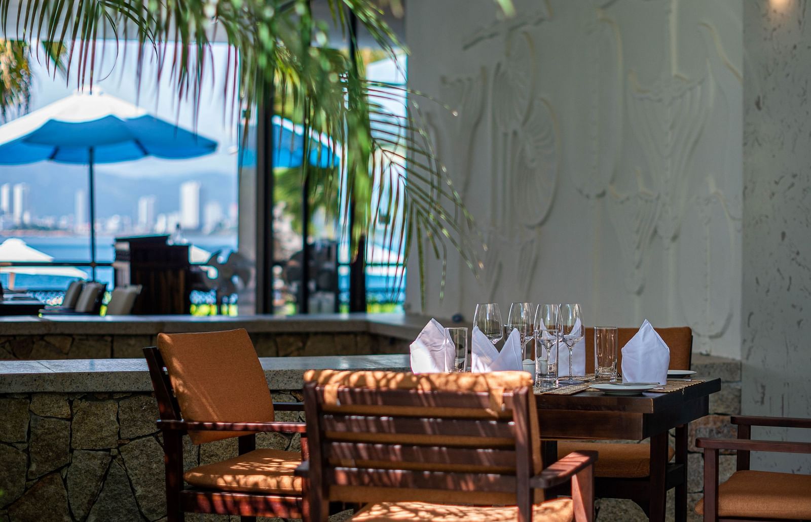 An image of a table and chairs at the corner - Alibu Resorts Nha Trang