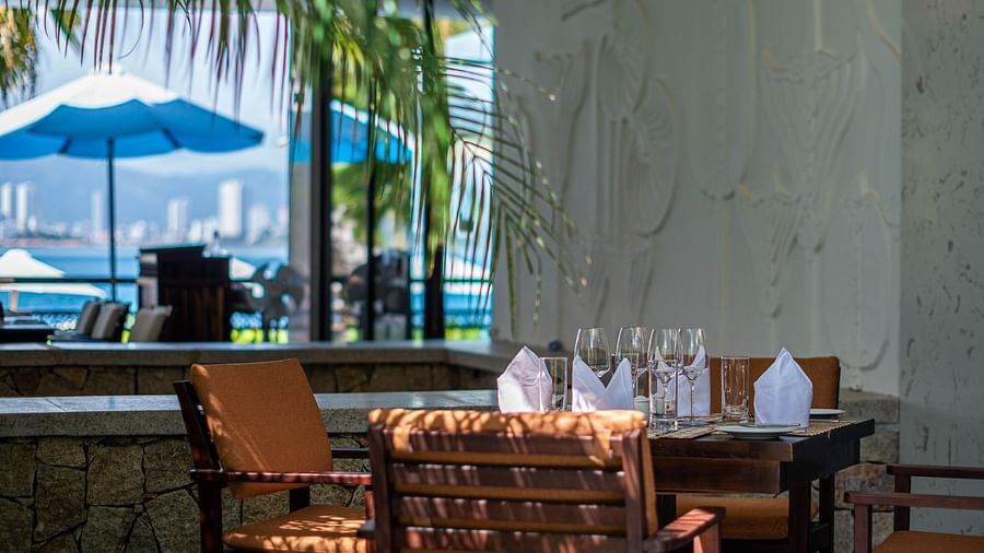 An image of a table and chairs at the corner - Alibu Resorts Nha Trang