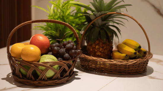 A counter top adorned with fresh fruits and a potted plant in a corner - Lamrin Morjim Goa