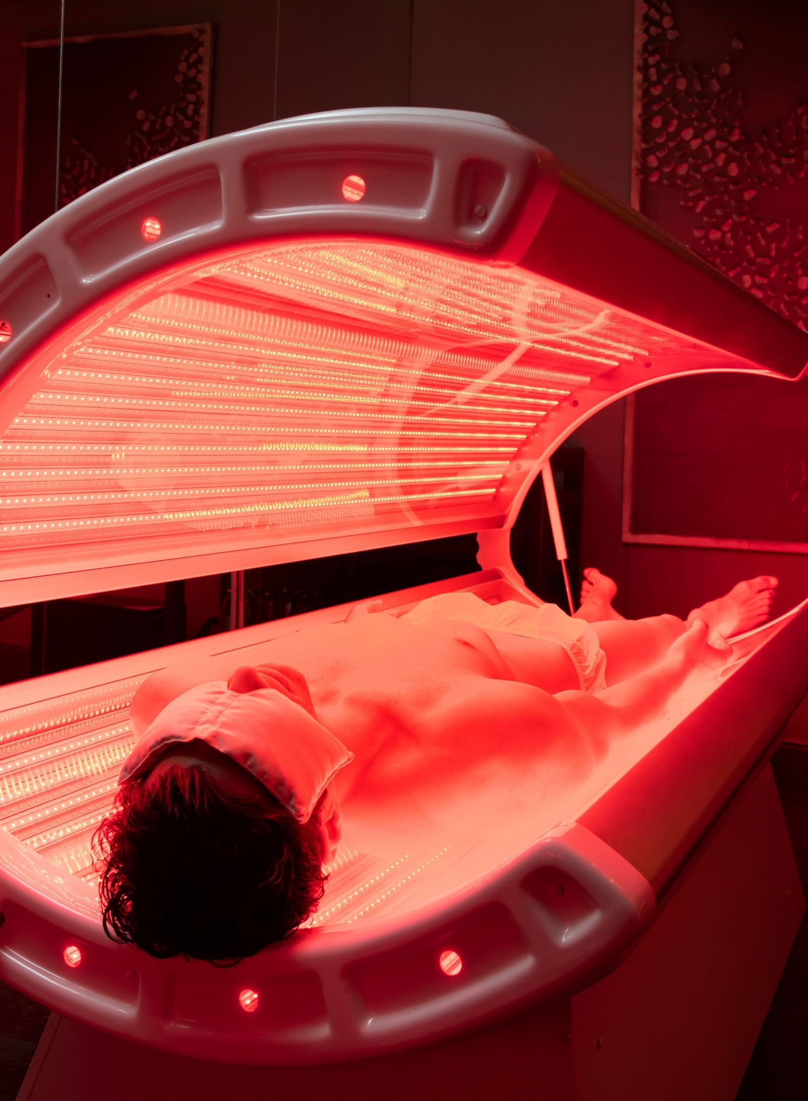 An image of a person enjoying red light therapy at our spa in New Delhi - Claridges Collection