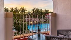 Balcony at Superior Room with chair and table at Heritage Village Resorts & Spa, Goa.