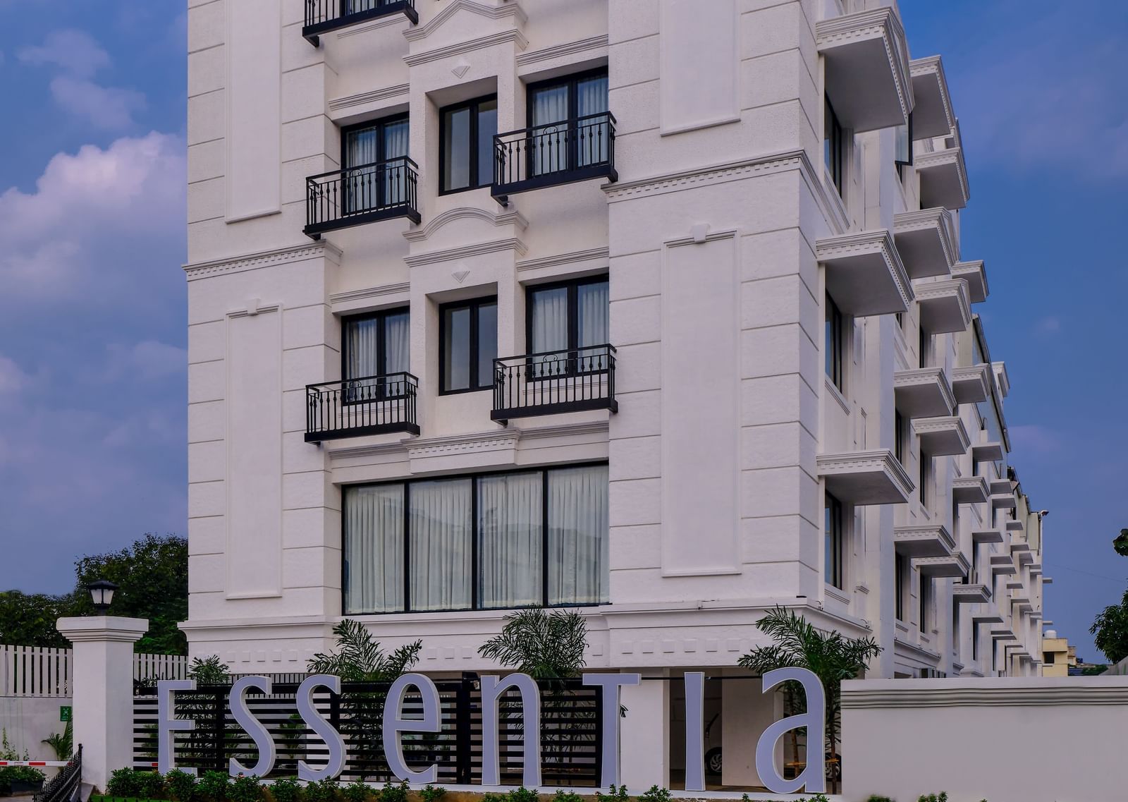 Facade of Essentia Premier Hotel, Chennai during a clear, blue day.