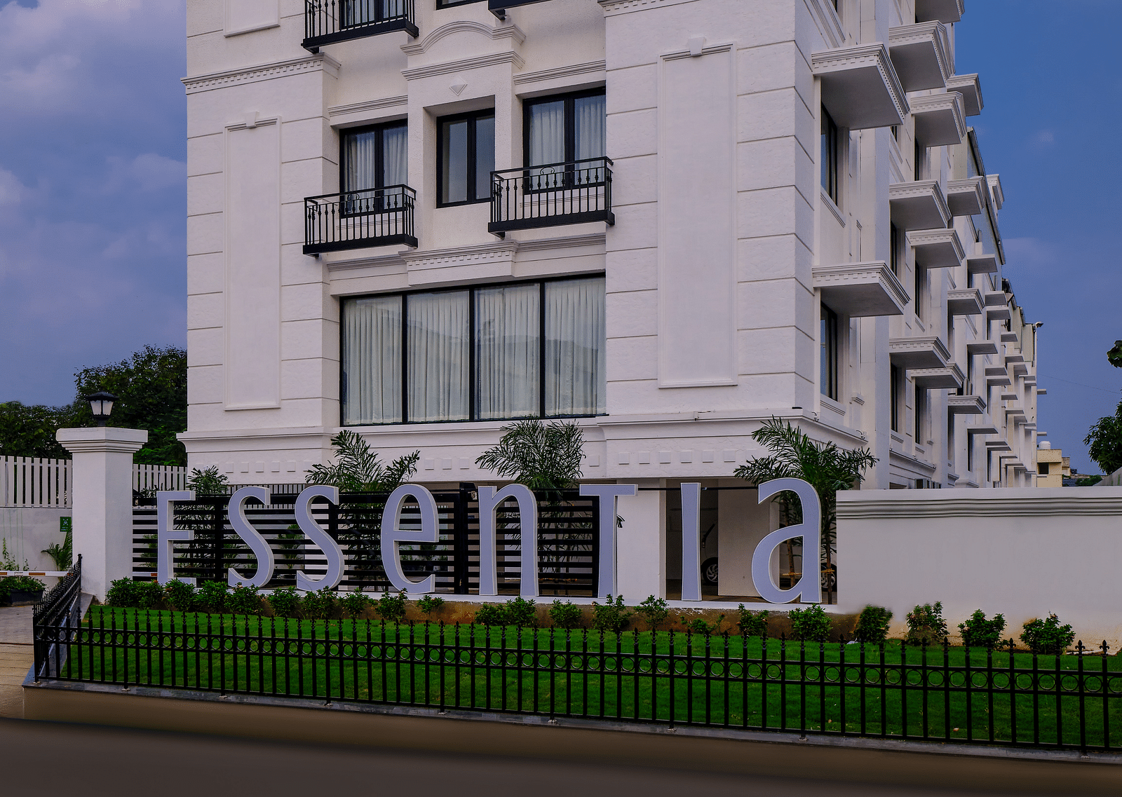 Facade of Essentia Premier Hotel, Chennai during a clear, blue day.