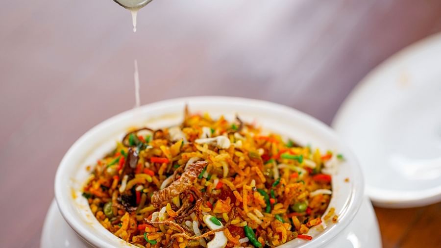 a meal being garnished with ghee on a table 