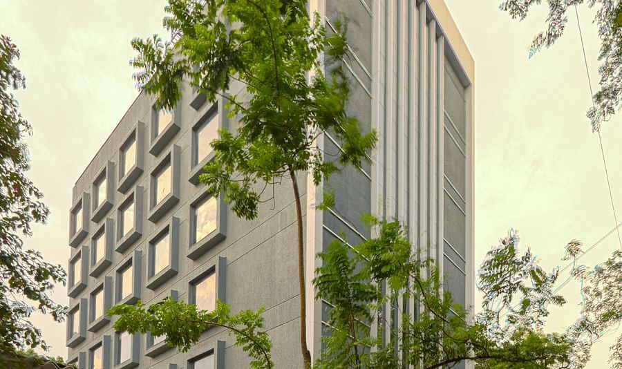 Facade image of Nexstar Suites in pune with trees next to it