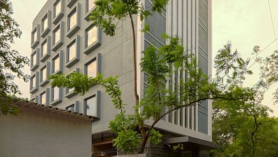 Facade image of Nexstar Suites in pune with trees next to it