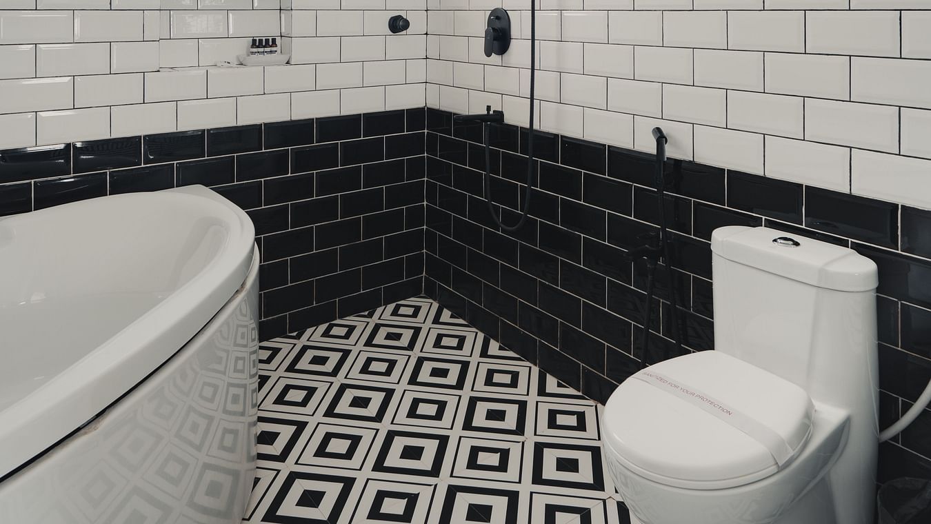 Stylish bathroom with black-and-white tiles in Three BHK Premium Villa, Richmonde Ananta Elite, Goa.