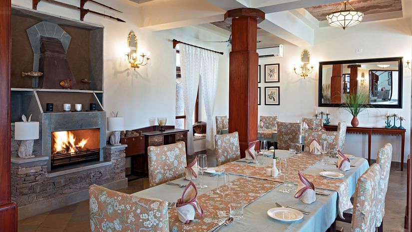 Seating arrangements inside the Restaurant and a chandelier on the ceiling - Chunda Shikar Oudi