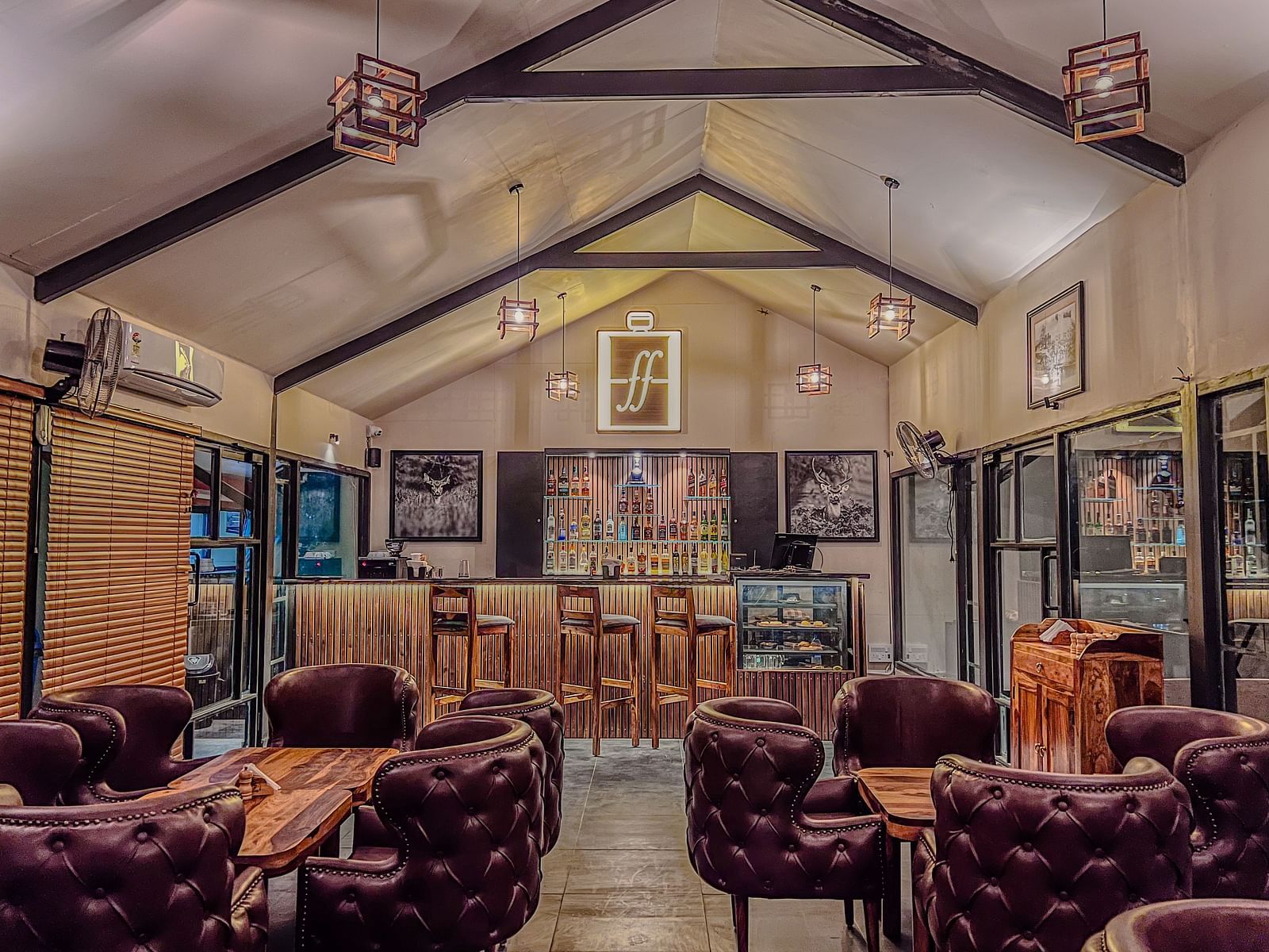 full view image of the forest flask restaurant at aranya vilas with chic interiors and magenta coloured cushioned chairs