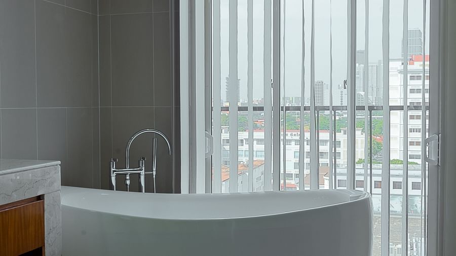 A bathroom with a standalone bathtub and floor-to-ceiling windows | Penthouse | Central Mansions, Phnom Penh