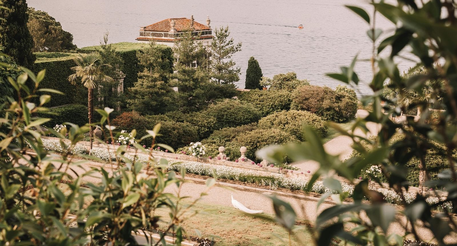image of a garden with lush greenery with lake views from the garden nestled amidst the mountains