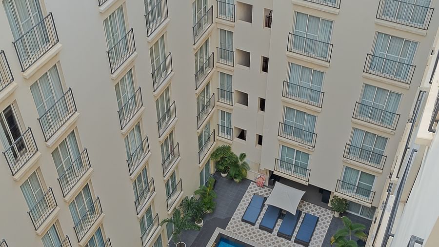 A vertical view of a building with a swimming pool in the courtyard | Central Mansions, Phnom Penh