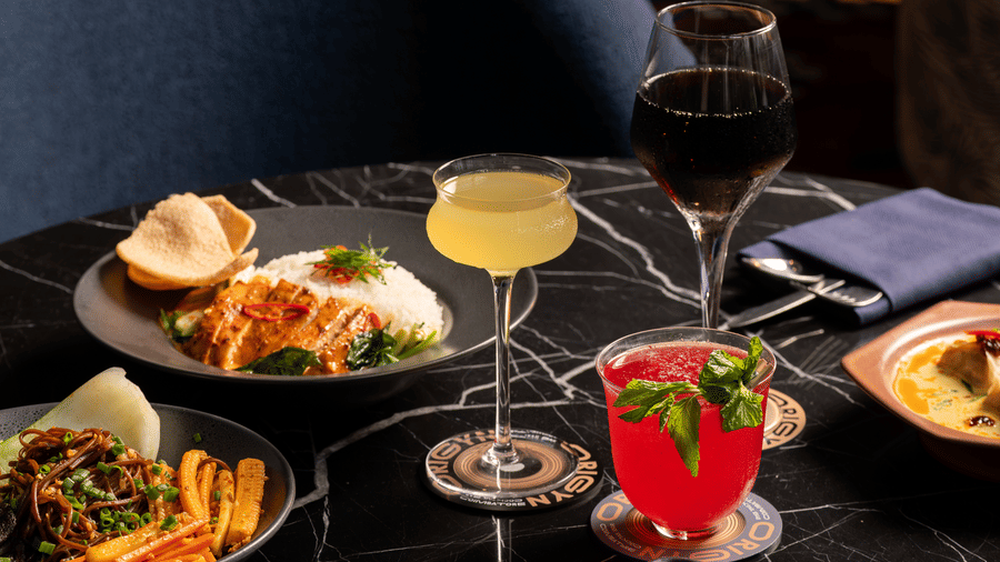 Multiple dishes and drinks arranged on a table at Origyn, Merlis Hotel, Coimbatore.