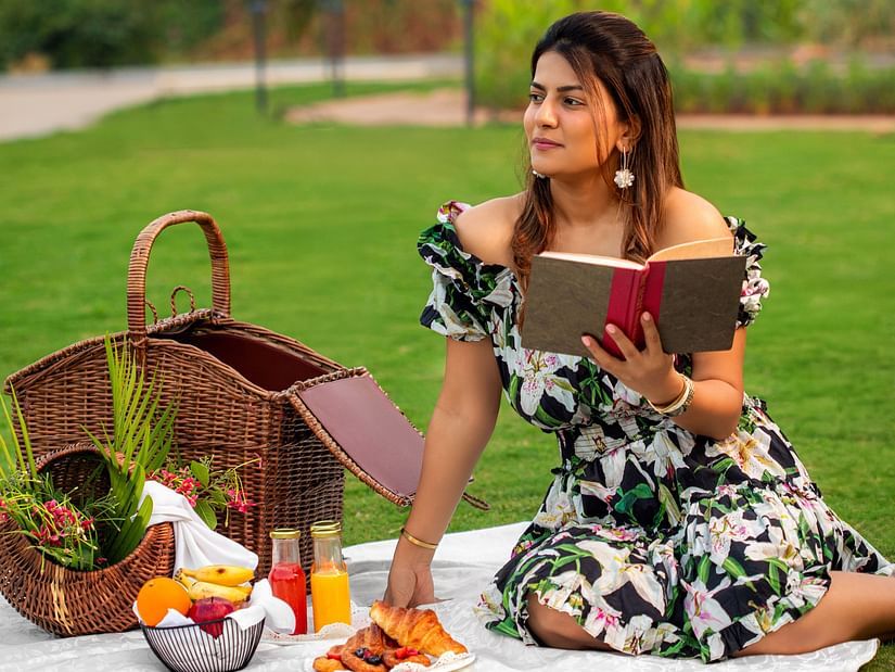 Woman reading a book during a garden picnic at The Dukes Retreat’s lush lawn area