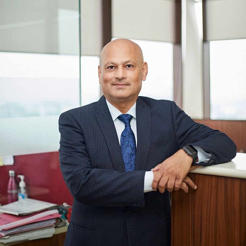 Manoj Soni standing in his office, placed his hands on the table.