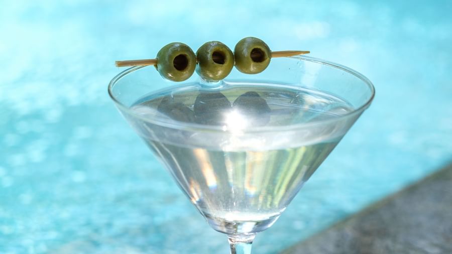 A glass of Martini with olives in a toothpick | Mango Hill, Pondicherry