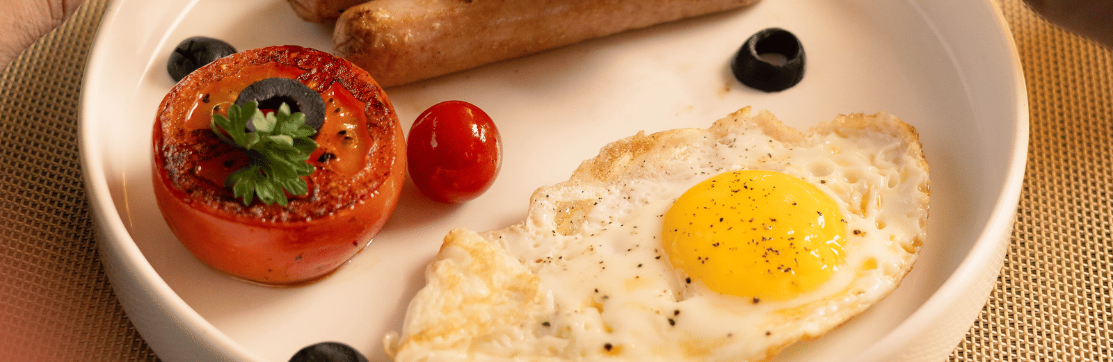 A breakfast plate with toast, sunny side up eggs, cherry tomatoes, and a hot beverage - Megha Resort & Villas, Dehradun