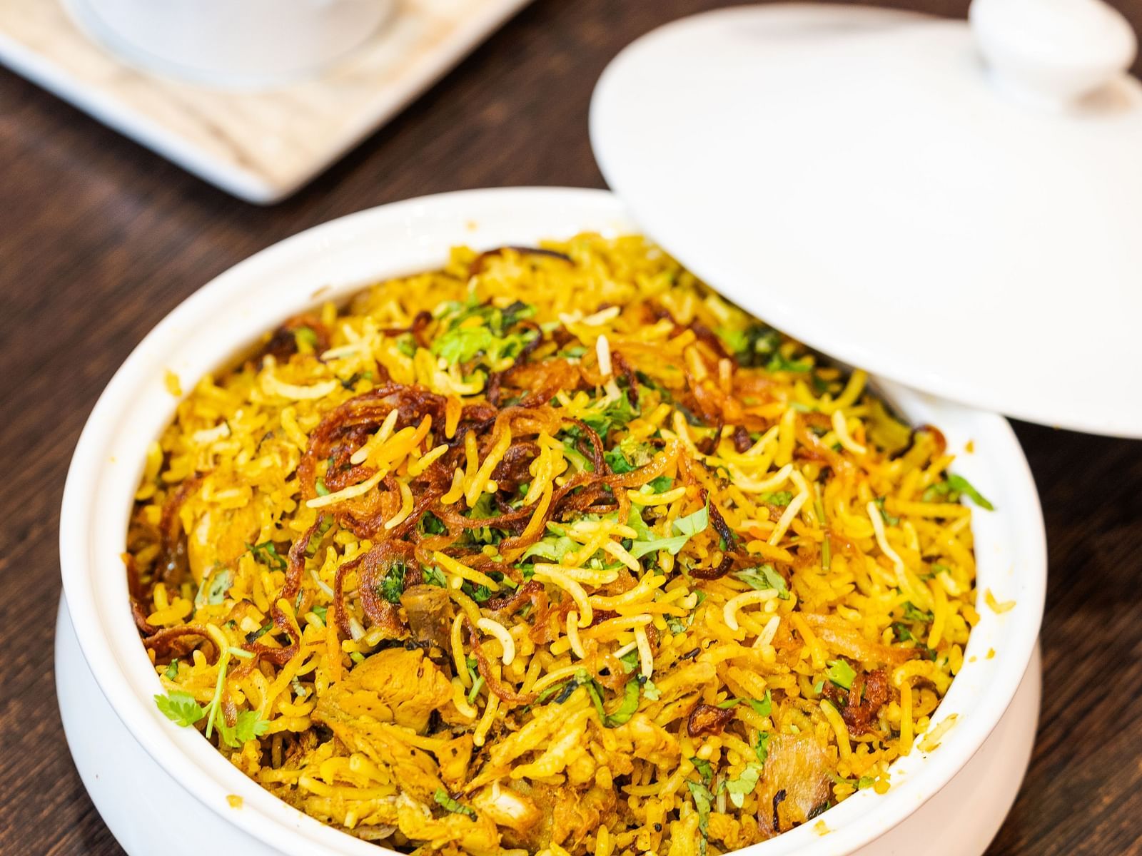 biryani served in a white bowl - Jardin Hotels