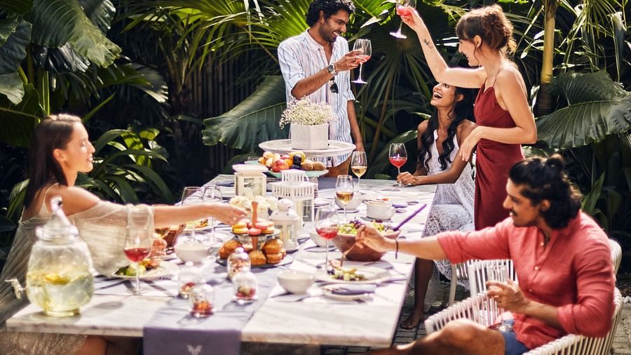 A group of people in an outdoor setting having meal.