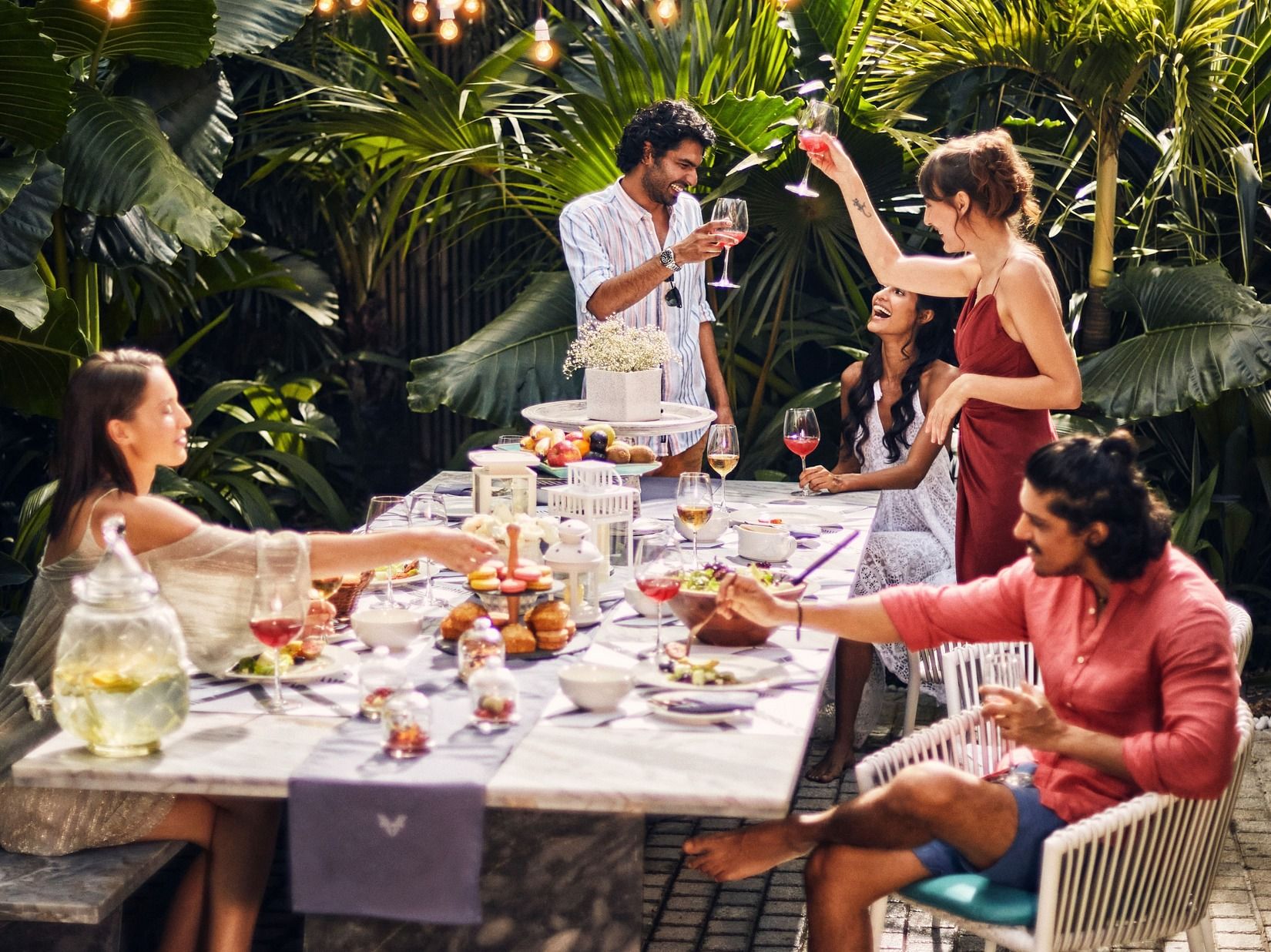 A group of people in an outdoor setting having meal.