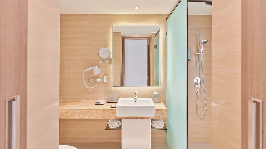 A sink and a mirror in the washroom | The Resort