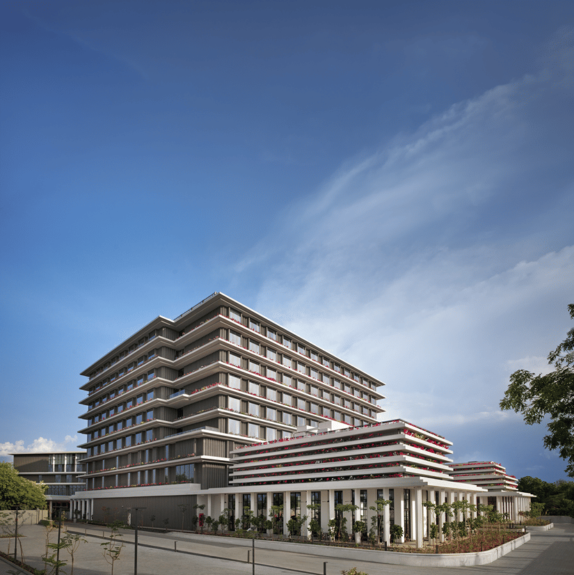 Hotel building facade captured against a bright blue sky at The Residency Signature Madurai.