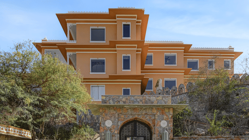 Khas Mahal Suites, Udaipur, featuring a vintage car parked in front of it.