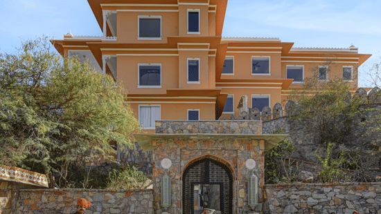 Khas Mahal Suites, Udaipur, featuring a vintage car parked in front of it.